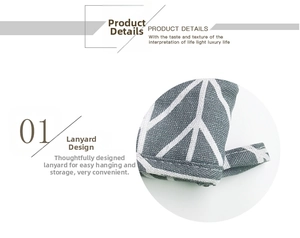 Detail view of grey linen oven mitt featuring white geometric pattern and hanging loop