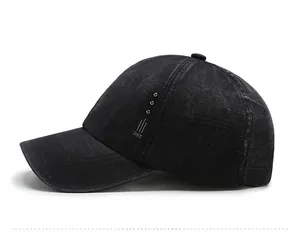 Side view of black washed cotton baseball cap with DST print and metal rivet accents