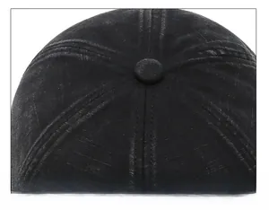 Close-up of the meticulous crown stitching and fabric texture on a black cotton baseball cap
