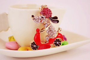 Detailed close-up of sparkling rhinestone puppy on a bike metal keychain charm