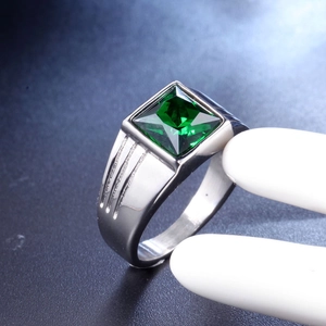 Detail of vintage silver titanium ring featuring a large square green gemstone on a stand