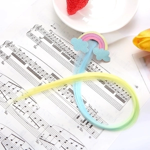 Macro view of rainbow cloud glitter hair clip with long gradient synthetic hair extensions