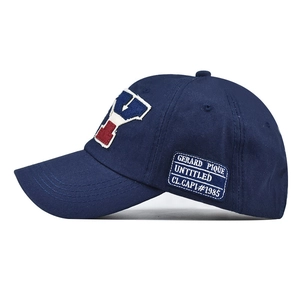 Detailed view of embroidery and vintage side patch on navy cotton baseball cap