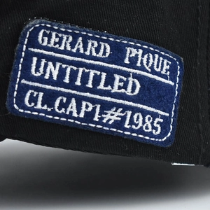 Detail of embroidered patch on black cotton baseball cap with high quality stitching