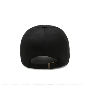 Rear view of black cotton baseball cap showing adjustable antique bronze metal buckle