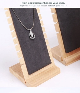 Detail of bamboo necklace stand with black velvet slots for jewelry display