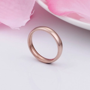 Minimalist rose gold plated titanium steel ring with a smooth polished finish shown from a side angle