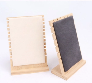 Detail of wooden jewelry display stand with velvet lining and side hanging hooks