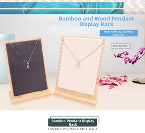 Close-up of bamboo jewelry display board with grey and beige velvet lining for necklaces
