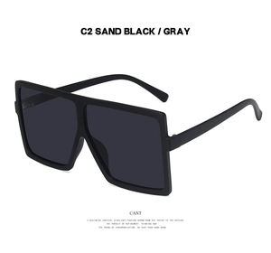Detail of square oversized sunglasses in sand black frame with gray lenses