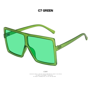Detail view of oversized square sunglasses in translucent C7 Green finish with wide bridge