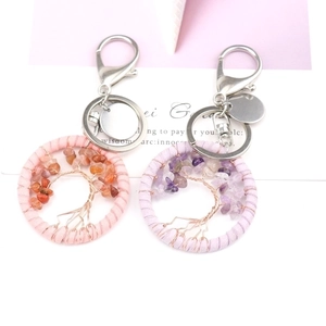 Detail shot of handmade Tree of Life dreamcatcher keychains in pink and purple quartz