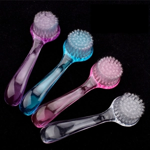Colorful set of four round nail dust brushes with transparent handles for manicure care