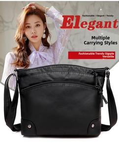 Detail of black faux leather crossbody bag featuring multiple zippers and silver rivets