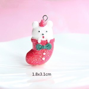 Macro shot of resin Christmas bear in red stocking charm with glitter, size 1.8x3.1cm
