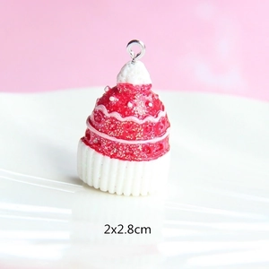Detail of Christmas resin pendant featuring red and white cupcake hat design with glitter