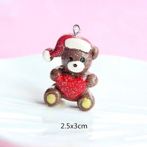 Macro view of a 2.5x3cm brown resin Christmas bear pendant with a red heart and glitter
