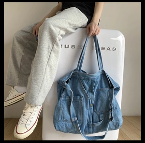 Relaxed retro washed blue denim tote bag with patchwork design and wide shoulder strap