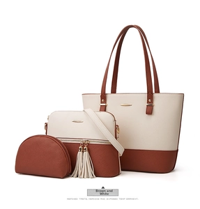 Detailed view of brown and white 3-in-1 tote bag set with tassel and gold hardware