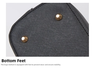Detail view of the tote bag bottom featuring black Saffiano leather and gold metal feet studs