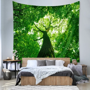 Detail view of large forest canopy tapestry hung above a wooden bed in a bedroom