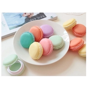 Portable macaron-shaped jewelry storage boxes in colorful pastel finishes on a table