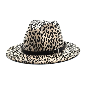 Detail of leopard print fedora hat with a black leather belt and silver metal buckle