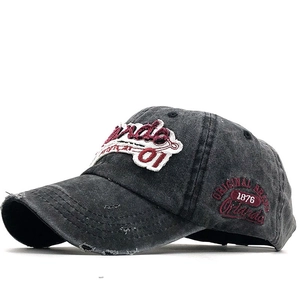 Detail of vintage washed cotton baseball cap with red Orlando 01 embroidery and distressed holes