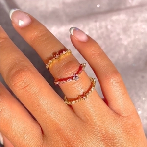 Close-up of three 18K gold-plated S925 silver rings with flowers and butterflies