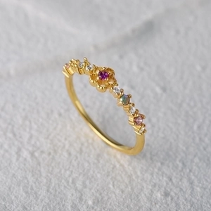 Close-up of S925 silver flower ring featuring colorful zircons and golden finish detail