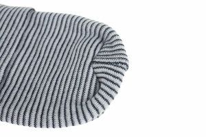 Detailed macro view showing the gray and black striped knit cotton fabric texture and seams