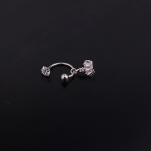 Detail of silver crown pendant with rectangular zircons on a curved stainless steel stud
