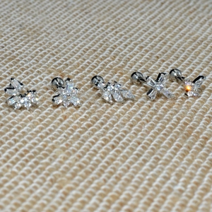 Set of five silver steel stud earrings featuring zircon shapes with screw back closures