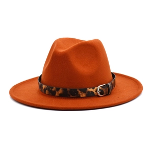 Detailed close-up of orange wool fedora hat featuring a leopard print belt and buckle