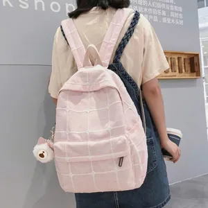 Pink checkered backpack for women with white cat plush keychain and padded straps