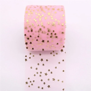 Detail of pink tulle roll with golden stars for DIY hair bows and dress accessories