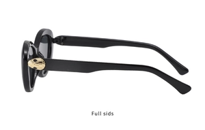 Close-up of golden snake head detail on black cat-eye sunglasses side frame