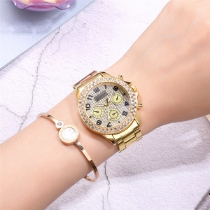 Geneva women's gold quartz watch with rhinestone bezel and matching shell bracelet