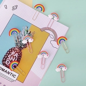 Set of 8 colorful rainbow and cloud PVC paperclips on a decorative notepad backdrop