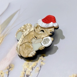 Creative acrylic squirrel brooch with a red Santa hat and snowflake detail for Christmas gift