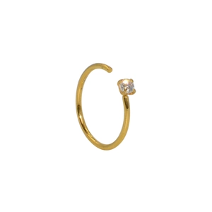 Detail of a gold C-shaped nose ring with a sparkling clear cubic zirconia stone