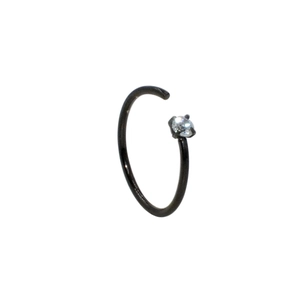 Detail of a black stainless steel C-shaped nose ring with a clear zircon stone inlay