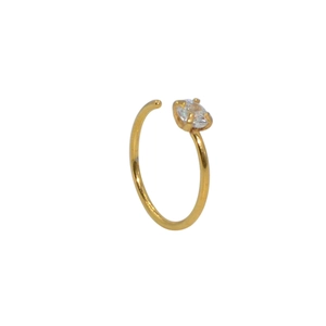 Detail of golden stainless steel C-shape nose ring with a sparkling zircon gemstone