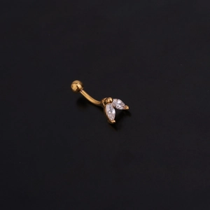 Close-up of golden stainless steel eyebrow ring with teardrop zircon crystals