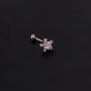 Macro detail of snowflake eyebrow piercing with clear zircon and silver stainless steel bar