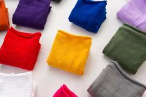 Close-up of colorful velvet socks showing rib-knit texture in multiple vibrant colors