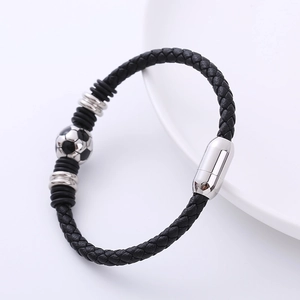 Macro detail of braided leather sports bracelet with soccer bead and magnetic steel clasp