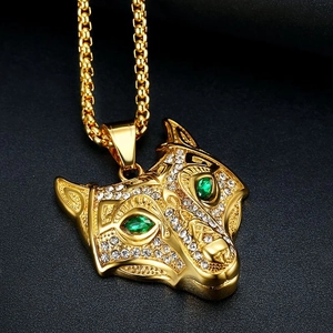 Gold Viking wolf head necklace with sparkling rhinestones and green gem eyes