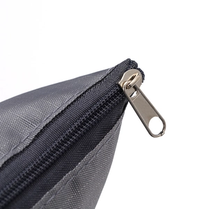 Detail view of gray travel storage bag zipper, premium fabric and durable metal slider.