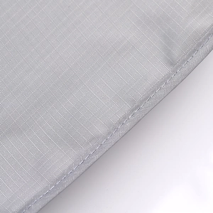 Close-up detail of grey travel organizer fabric showing fine stitching texture and quality.